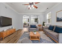 Inviting living room with an open concept layout, seamlessly connected to the kitchen and dining area at 1104 Pebblestone Drive, Durham, NC 27703