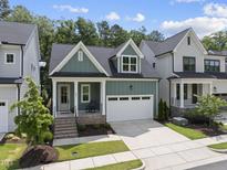 Charming two-story home featuring a neatly manicured lawn and an attached two-car garage at 167 Monteith Dr, Chapel Hill, NC 27516