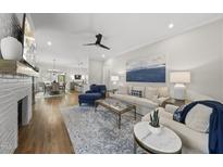 Bright living room with hardwood floors, a fireplace, and stylish furniture at 167 Monteith Dr, Chapel Hill, NC 27516