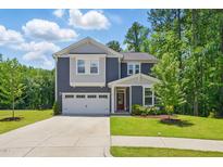 Charming two-story home features a well-manicured lawn and an attached two-car garage at 187 Harpers Landing Rd, Garner, NC 27529
