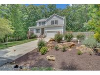 Charming two-story home with gray siding, landscaped yard, and inviting curb appeal at 2310 Turning Pointe Way, Hillsborough, NC 27278