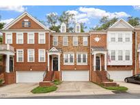 Charming townhomes featuring brick exteriors, front-entry garages, and manicured landscaping in a desirable neighborhood at 2614 Laurelcherry St, Raleigh, NC 27612