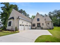 Stunning brick home with a three-car garage and a well-manicured lawn, creating an inviting curb appeal at 2713 Trifle Lane Ln, Wake Forest, NC 27587