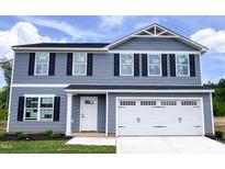 Two-story home with a white garage door, gray siding, and black shutters under a bright, cloudy sky at 305 Rosewood Dr, Sanford, NC 27330