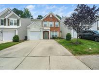 Charming brick and siding home with a well-maintained lawn and a one-car garage at 306 Berlin Way, Morrisville, NC 27560
