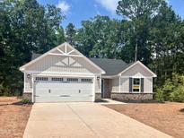 Charming single-story home with a two-car garage and a welcoming facade at 311 Rothbury Ct, Sanford, NC 27330