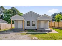 Charming duplex featuring individual entrances, symmetrical design, and inviting front porches at 414 Craven St, Durham, NC 27704