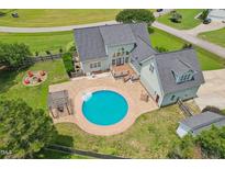 Stunning aerial view of home featuring a private pool, outdoor fireplace, and meticulously landscaped backyard at 5405 Overdale Ln, Raleigh, NC 27603