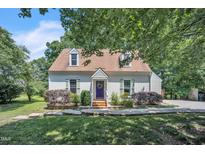 Charming home featuring dormer windows, a peaked roof, and a welcoming purple front door at 6328 Jones Farm Rd, Wake Forest, NC 27587