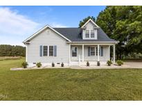 Charming single-story home featuring a welcoming front porch and well-manicured lawn at 820 Water Plant Rd, Zebulon, NC 27597
