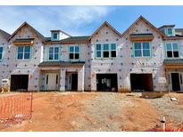 New townhomes under construction featuring covered garages, craftsman windows and modern architectural design at 87 Ripple Way # 214, Clayton, NC 27520