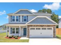 Beautiful two-story home with stone accents, blue shutters and a two-car garage at 960 Sandyhill Rd, Wendell, NC 27591