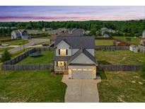 Charming two-story home with a well-manicured lawn and a two-car garage at 102 Williamson Place Dr, Princeton, NC 27569