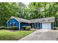 Charming single-story home with well-maintained landscaping and a welcoming driveway at 103 Summerlin Dr Dr, Chapel Hill, NC 27514