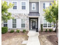 Charming home exterior with stone accents, a covered entrance, and a well-manicured front yard at 1217 Great Egret Way, Durham, NC 27713