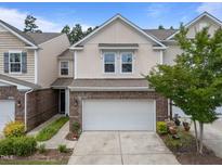 Charming two-story townhouse with a brick facade and a convenient attached two-car garage at 1413 Glenwater Dr, Cary, NC 27519