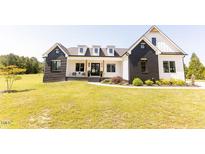 Stunning two-story home featuring a modern design and well-maintained landscaping at 15 Magnolia Ln, Youngsville, NC 27596