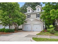 Charming two-story home featuring a two-car garage and well-maintained landscaping at 2018 Remington Oaks Cir, Cary, NC 27519