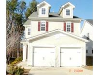 Charming two-story home featuring a two-car garage and dormer windows at 2018 Remington Oaks Cir, Cary, NC 27519