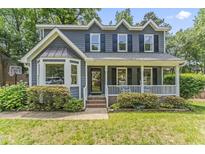 Charming two-story home with a covered front porch, well-maintained lawn, and manicured landscaping at 2708 Halfhitch Trl, Raleigh, NC 27615