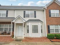 Charming townhouse featuring a covered entryway, bay window, and a mix of siding and brick facade at 2845 Bennington Dr, Clayton, NC 27520