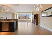 Spacious living room with hardwood floors and bright natural light from large windows overlooking the city at 400 W North St # 604, Raleigh, NC 27603