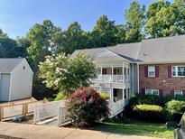 Charming condo building featuring lovely landscaping, and quaint walkway and staircases at 411 Gooseneck Dr # A1, Cary, NC 27513
