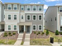 Attractive townhouse with manicured landscaping, visible in this sunny exterior view at 5430 Crescent Square St, Raleigh, NC 27616