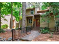 Charming home with a red front door, a black iron railing, and a landscaped walkway at 60 Stoneridge Rd, Durham, NC 27705