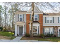 Charming townhouse with brick and siding, complemented by well-maintained landscaping and a welcoming front entrance at 610 Walnut Woods Dr, Morrisville, NC 27560