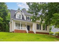 Charming two-story home with a welcoming front porch and well-manicured lawn at 8201 Ivymount Way, Raleigh, NC 27613