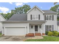 Charming two-story home with a well-manicured lawn, black shutters and a two car garage at 8912 Erinsbrook Dr, Raleigh, NC 27617