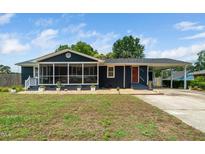 Charming single-story home boasts a screened porch, carport, and manicured landscaping at 914 Forest Dr, Garner, NC 27529