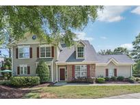 Charming two-story home with brick and siding, landscaped yard, and inviting front entrance at 9530 Vira Dr, Raleigh, NC 27617