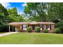 Charming single-story brick home with a covered carport and well-manicured front lawn at 103 Val Del Ct, Garner, NC 27529