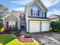 Charming two-story home with a two-car garage and well-manicured lawn at 117 Brierridge Dr, Apex, NC 27502