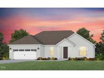 Charming single-story home with a two-car garage and a beautifully landscaped front yard at 118 Arcadius Dr, Clayton, NC 27520