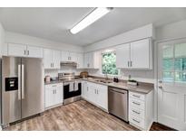 Updated kitchen featuring stainless steel appliances, white cabinets, and attractive countertops at 1209 Lochcarron Ln, Cary, NC 27511