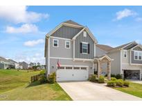 Charming two-story home with a well-maintained lawn and attached two-car garage at 209 Sage Oak Ln, Holly Springs, NC 27540