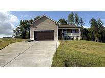 Charming single-Gathering home with a front porch and an attached two-car garage at 233 Constellation Ct, Benson, NC 27504