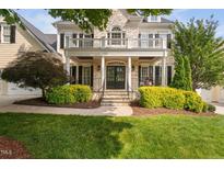 Elegant home featuring a stone facade, welcoming porch, and manicured landscaping at 3004 Montville Valley Ct, Cary, NC 27519