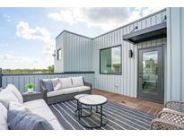 Relaxing rooftop deck featuring stylish outdoor furniture and views at 3007 Corbell Rd, Durham, NC 27701