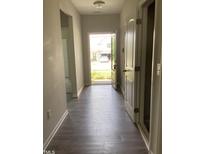 Inviting entryway featuring sleek wood-look floors and a view of the home's facade through an open door at 305 Theys Mill, Fuquay Varina, NC 27526