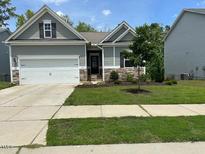 Charming single-Gathering home with a manicured lawn and an attached two-car garage at 305 Theys Mill, Fuquay Varina, NC 27526