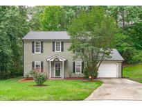 Charming two-story home with a well-manicured lawn and a classic facade at 3330 Nantuckett Ave, Durham, NC 27703