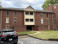 Brick apartment building with balconies and walkway entrance at 3601 Helix Ct # 301, Raleigh, NC 27606