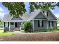 Charming home with gray siding, black shutters, well-maintained landscaping and inviting front entrance at 3684 Ben Mil Ct, Franklinton, NC 27525