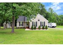 Charming single-story home with a well-maintained lawn and inviting curb appeal and exterior storage at 4524 Sugar Maple Rd, Oxford, NC 27565