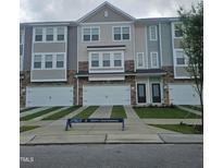 View of newly constructed townhomes with multi-toned exterior and private driveways at 5334 River Reach Dr, Raleigh, NC 27616