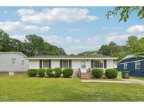 Charming single story home featuring a well-manicured lawn and inviting curb appeal at 555 Dacian Rd, Raleigh, NC 27610